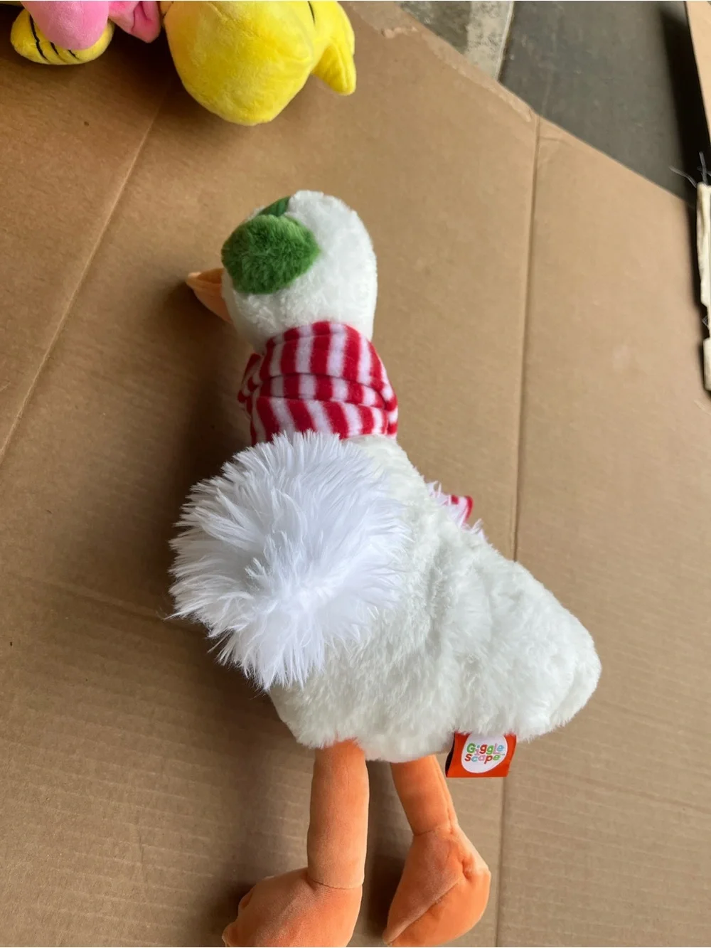 Plush Holiday Duck with Green Ear Muffs and Red Stripe Scarf